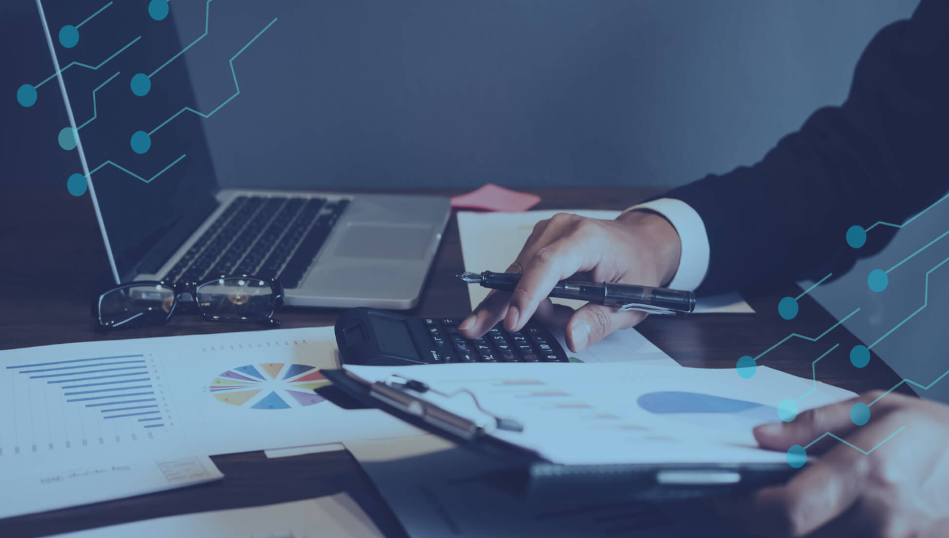 businessman working at a desk with printed dashboards and documents